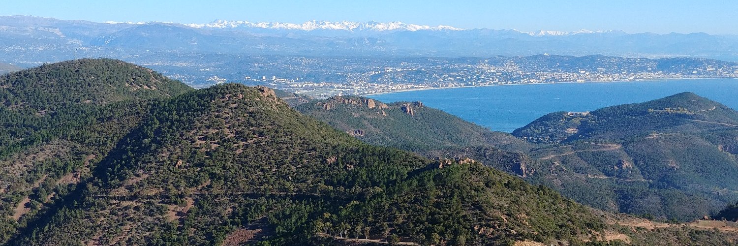 The Mediterranean and the snow-capped Alps seen from a hilltop on the French Riviera